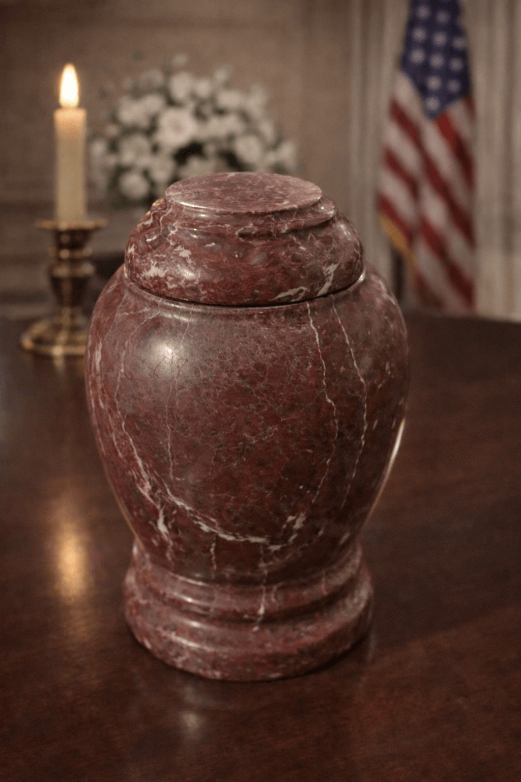 Elegant handcrafted red marble pet urn with natural veining and a secure lid